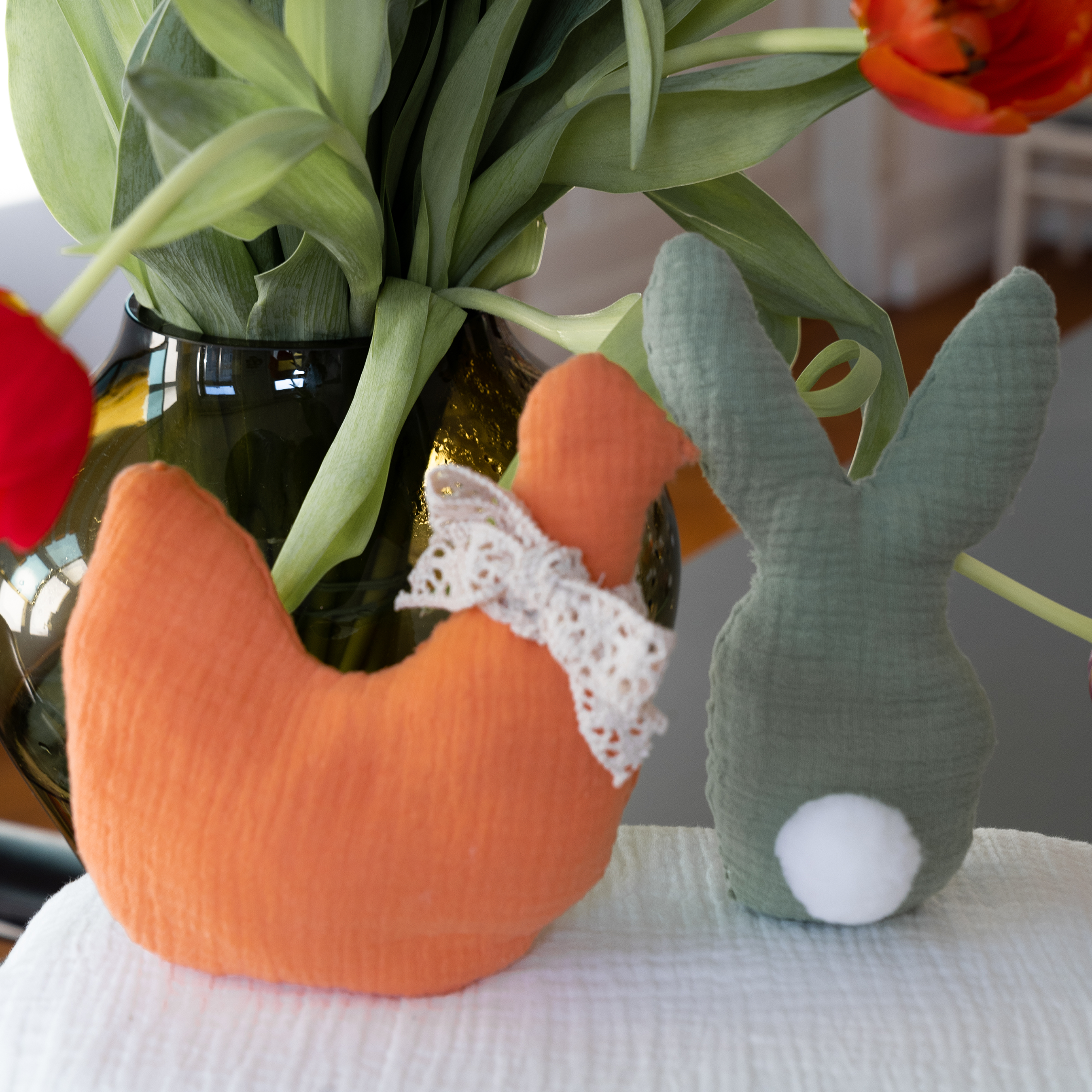 Stuffed chick and stuffed bunny in front of a bouquet of tulips